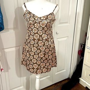 Cute Tilly’s dress never worn with tags still tan with cute flowers on it